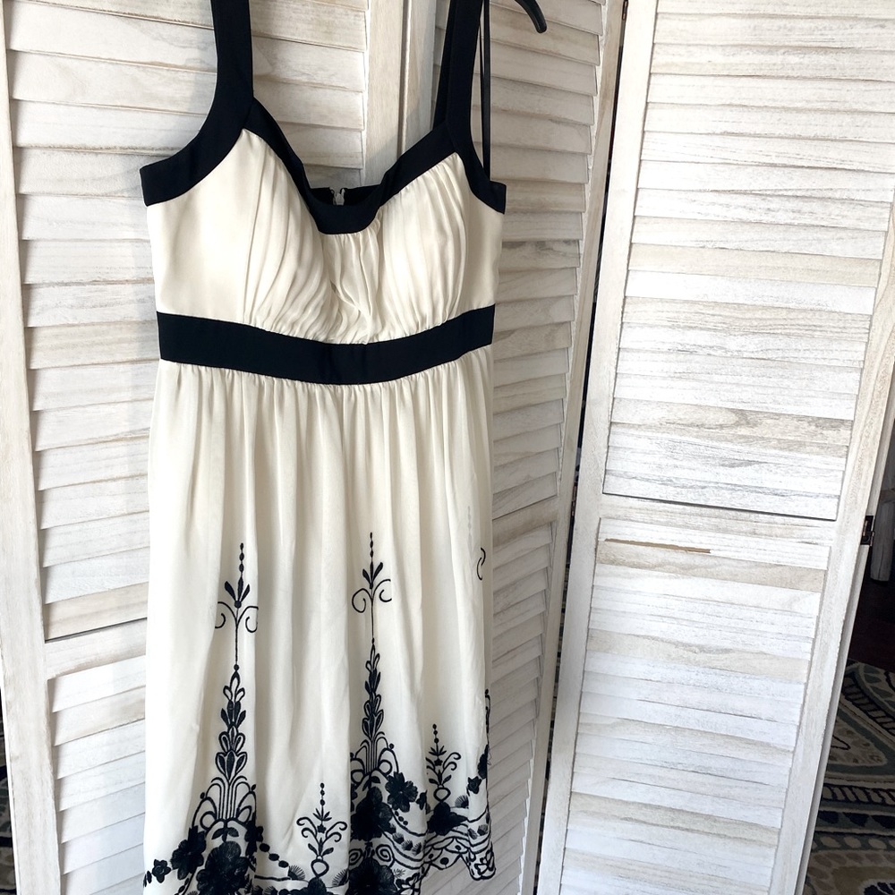 Party dress beige with black trims and embroidery on bottom of dress